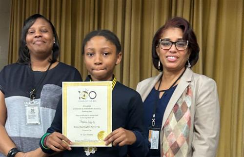 student holding certificate